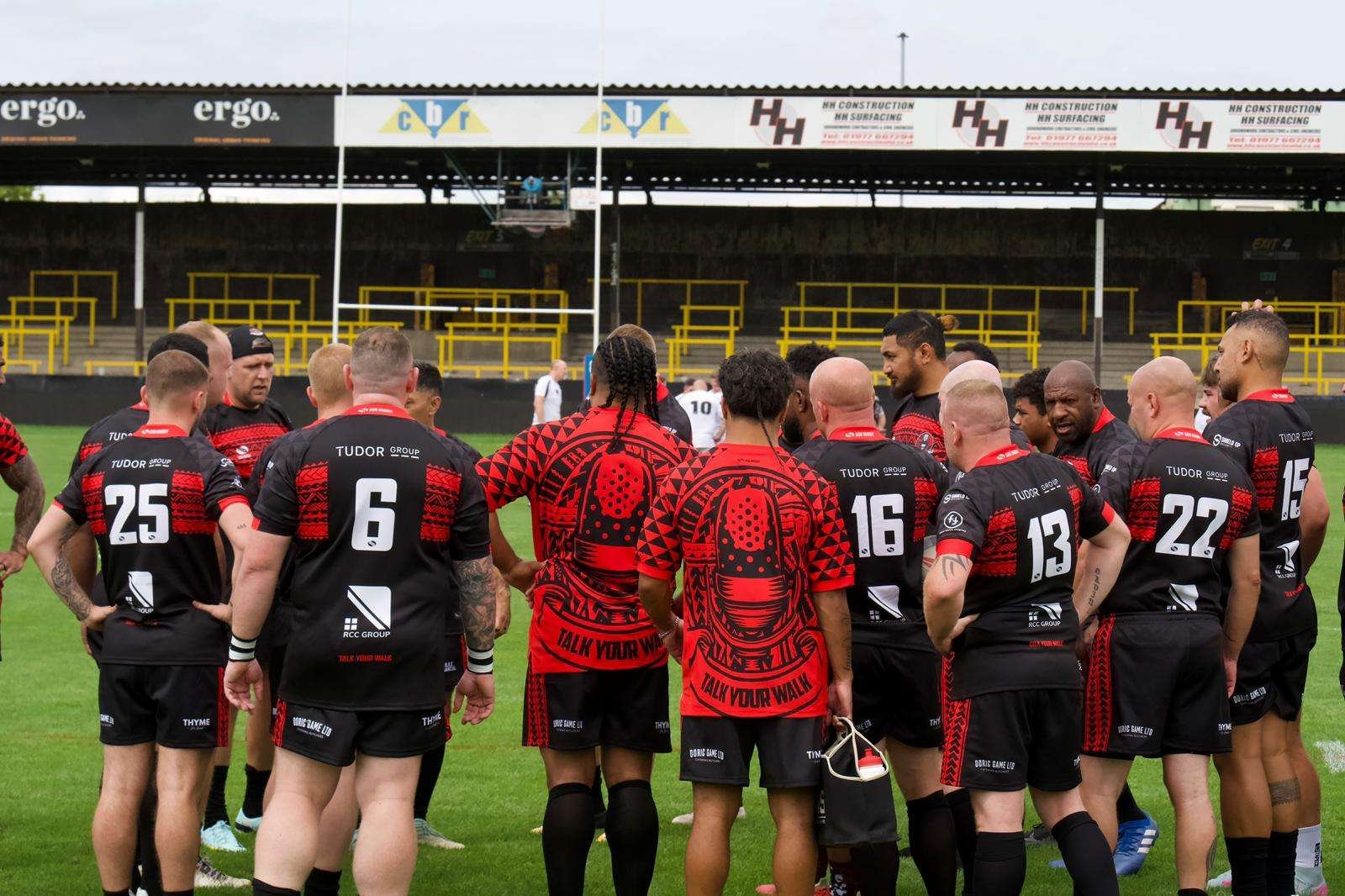Talk Your Walk team huddle on the rugby field
