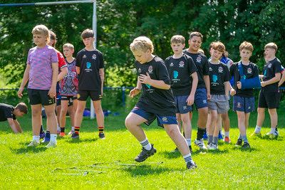 Young player sprinting through cones
