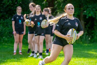 Girls academy player running with the ball