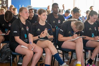 Players in classroom session taking notes